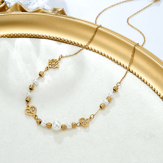 Collier perles dorées motifs spirales