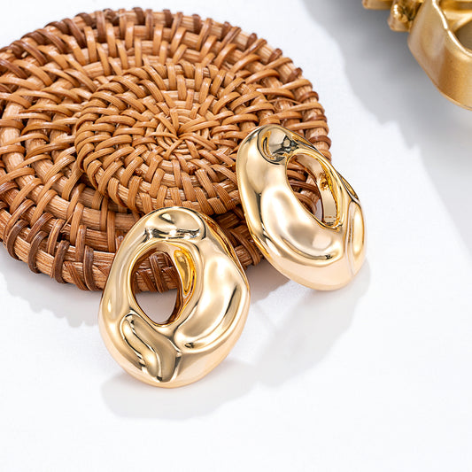 Boucles d'oreilles dorées fluides