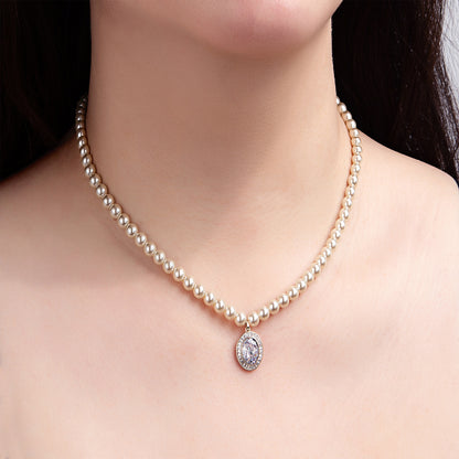 Collier perles dorées pendentif strass élégant