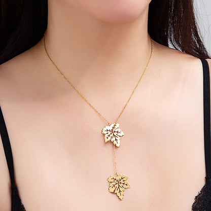 Collier pendentif double feuilles dorées